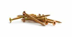 Close-up of gold-colored flange bolts with sharp threads, used in industrial machinery and construction for secure fastening.
