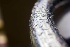 Close-up of a flange bolt with water droplets, showcasing precision manufacturing and high durability for industrial applications.