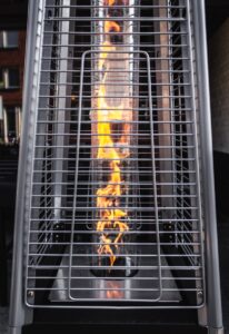 Industrial heater with visible flame and metal grill, used for manufacturing or industrial heating applications.