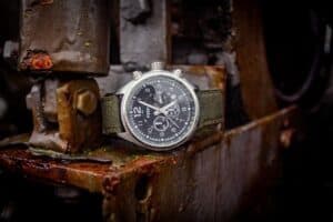 An industrial watch resting on rusted metal components, highlighting the importance of durable fasteners like flange bolts and screws in harsh environments.