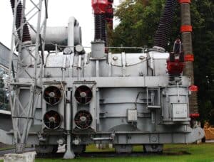 An industrial transformer housed in a robust metal enclosure with cooling fans and electrical connections, designed for reliable power distribution in mobile network base stations.