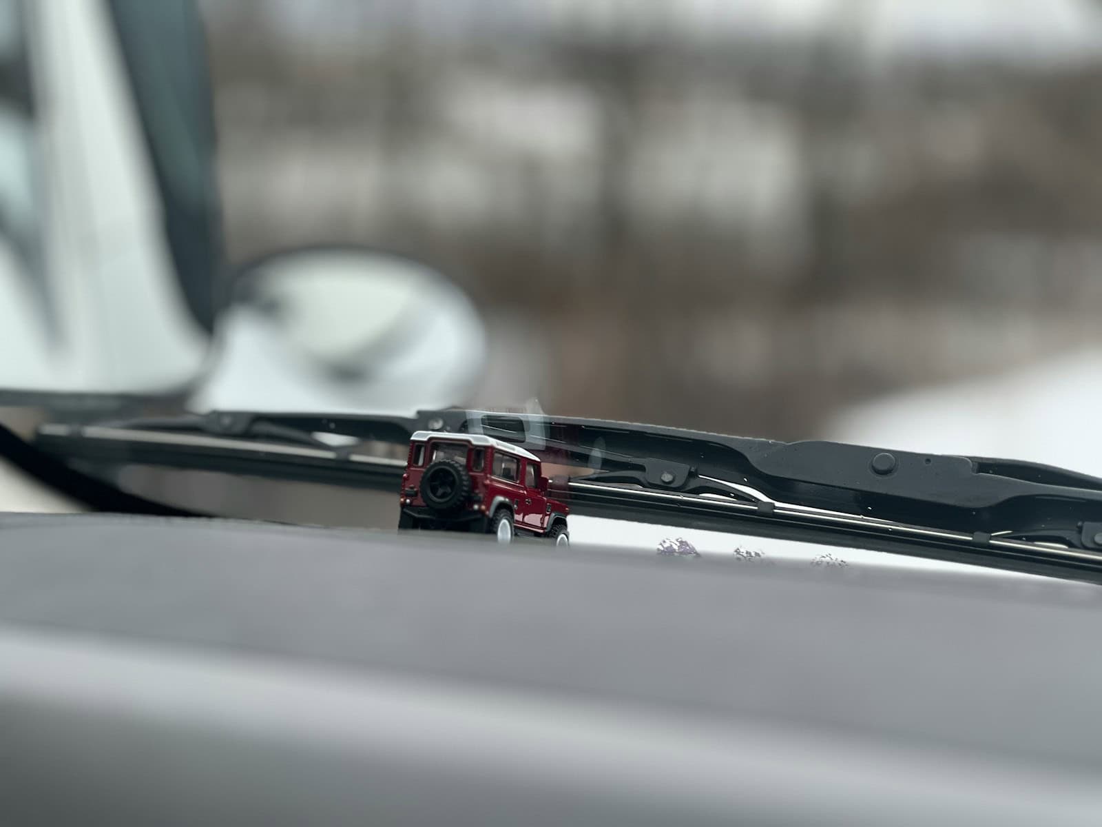 a toy truck is parked in front of a mirror