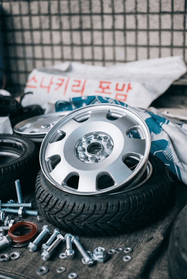 Colorful threads woven across a vintage car's windshield and body, illustrating intricate fastening techniques and thread types used in automotive assembly. Colorful threads woven across a vintage car's windshield and body, illustrating intricate fastening techniques and thread types used in automotive assembly.