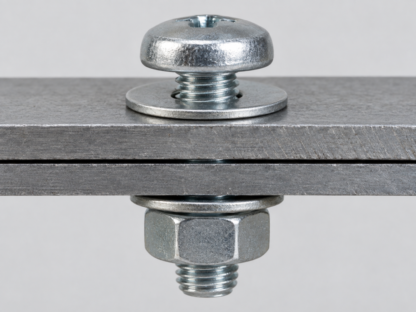Machine screw with matching nut and washer in a through-fastening assembly
